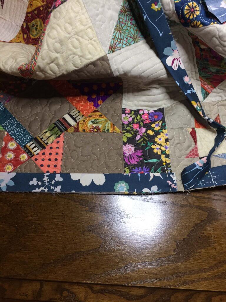 Position the quilt with the buik away from you and the two loose "tails" closest to you when you attach binding
