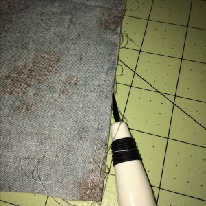 Pushing the seam ripper under the seam. 