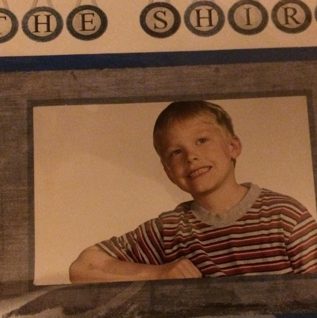 Picture of a little boy wearing a grey striped tshirt with text overlay - the shirt