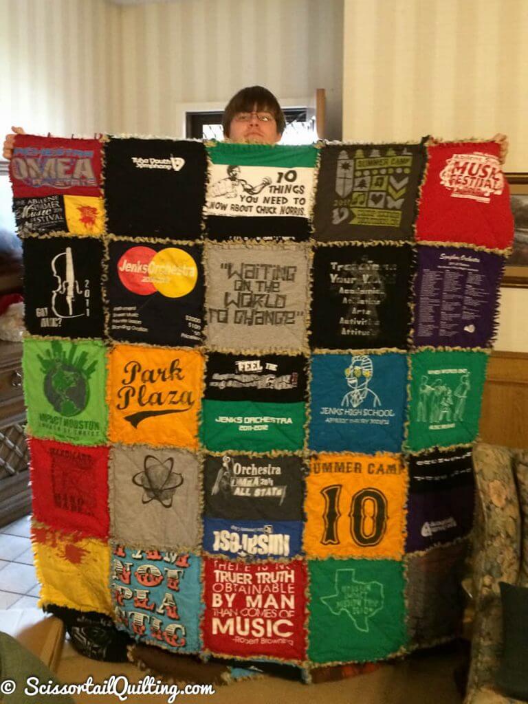 Young man holding a t-shirt quilt