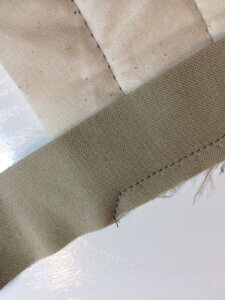 Photo showing how to sew off the corner of one binding edge
