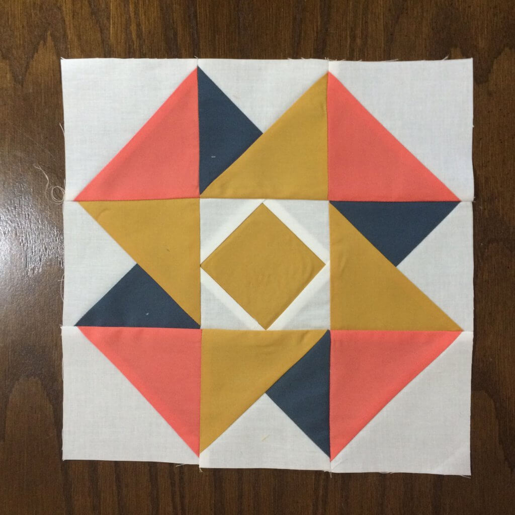 Photo of Completed Air Castle Quilt Block in peach, gold and navy