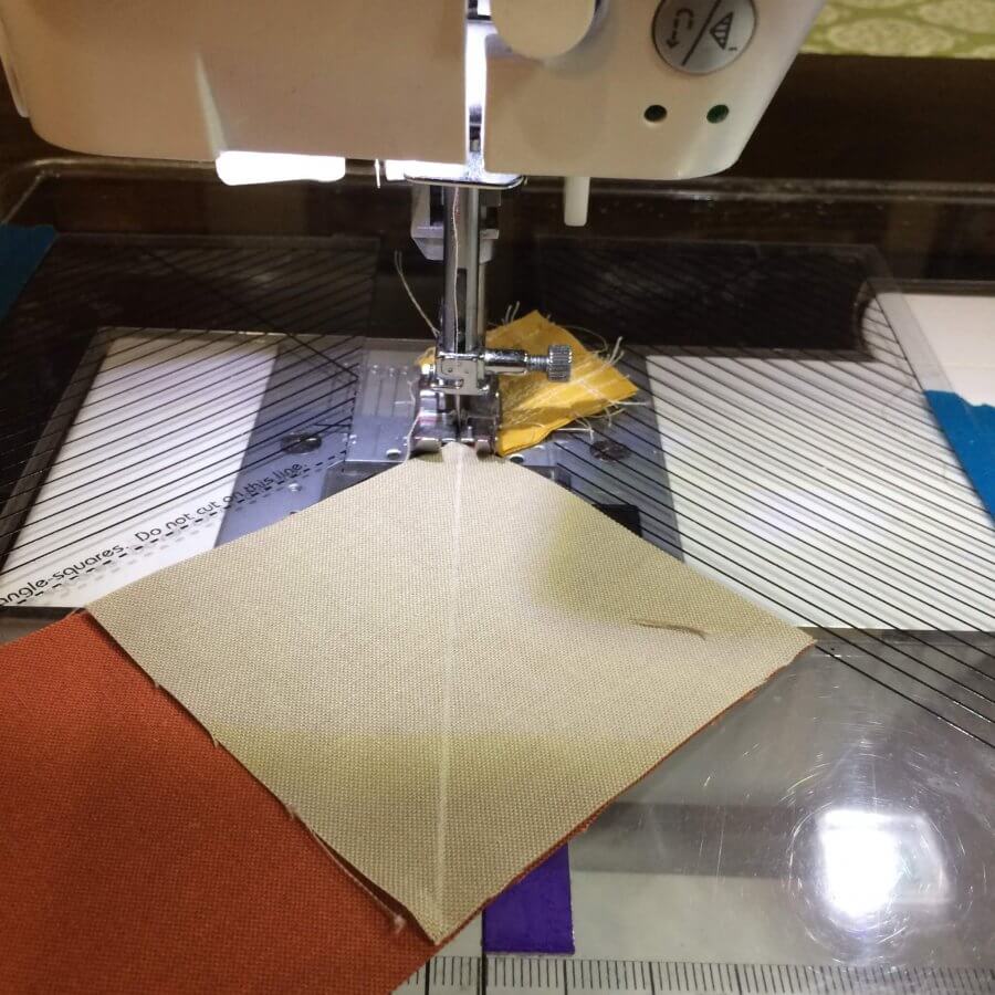 Image showing how to sew to right of center line when making flying geese.