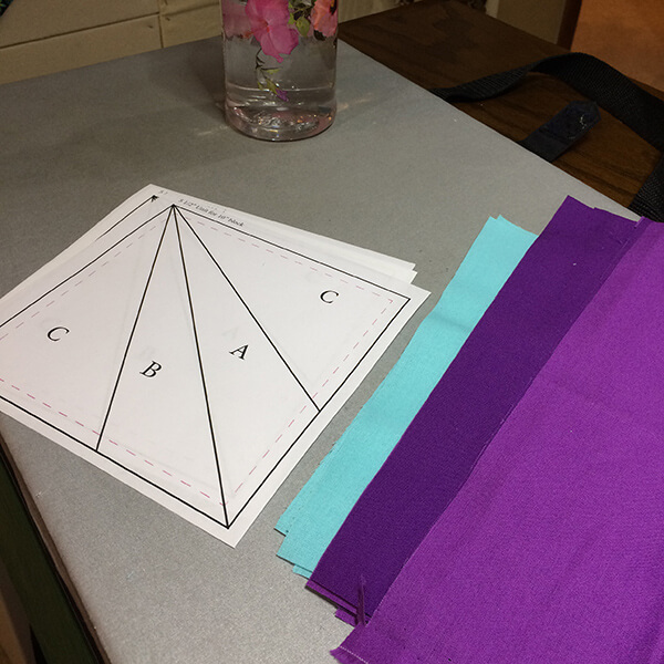 Photo of paper templates and fabrics ready. Let's learn how to paper-piece a quilt block