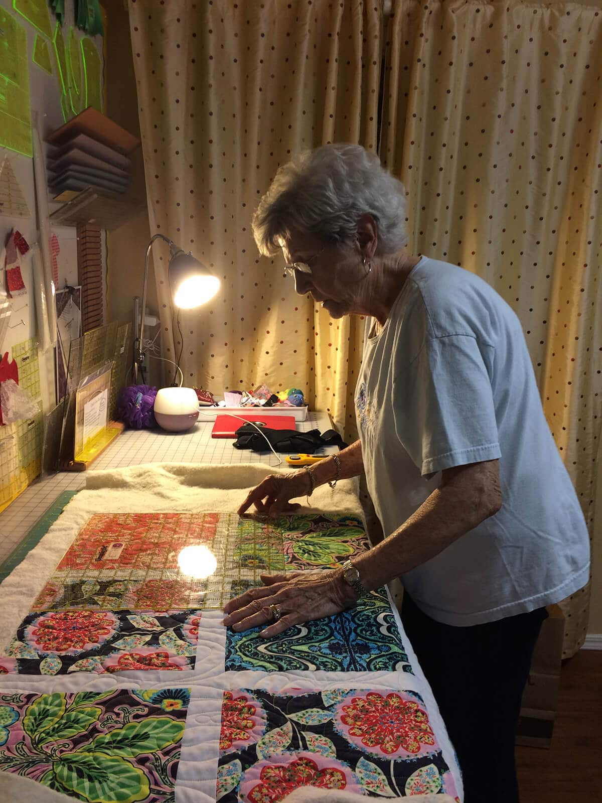 Woman trimming a quilt