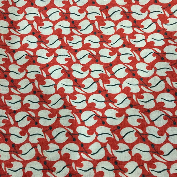 photo of Vintage Feedsack Fabric with red background ond white and black leaves