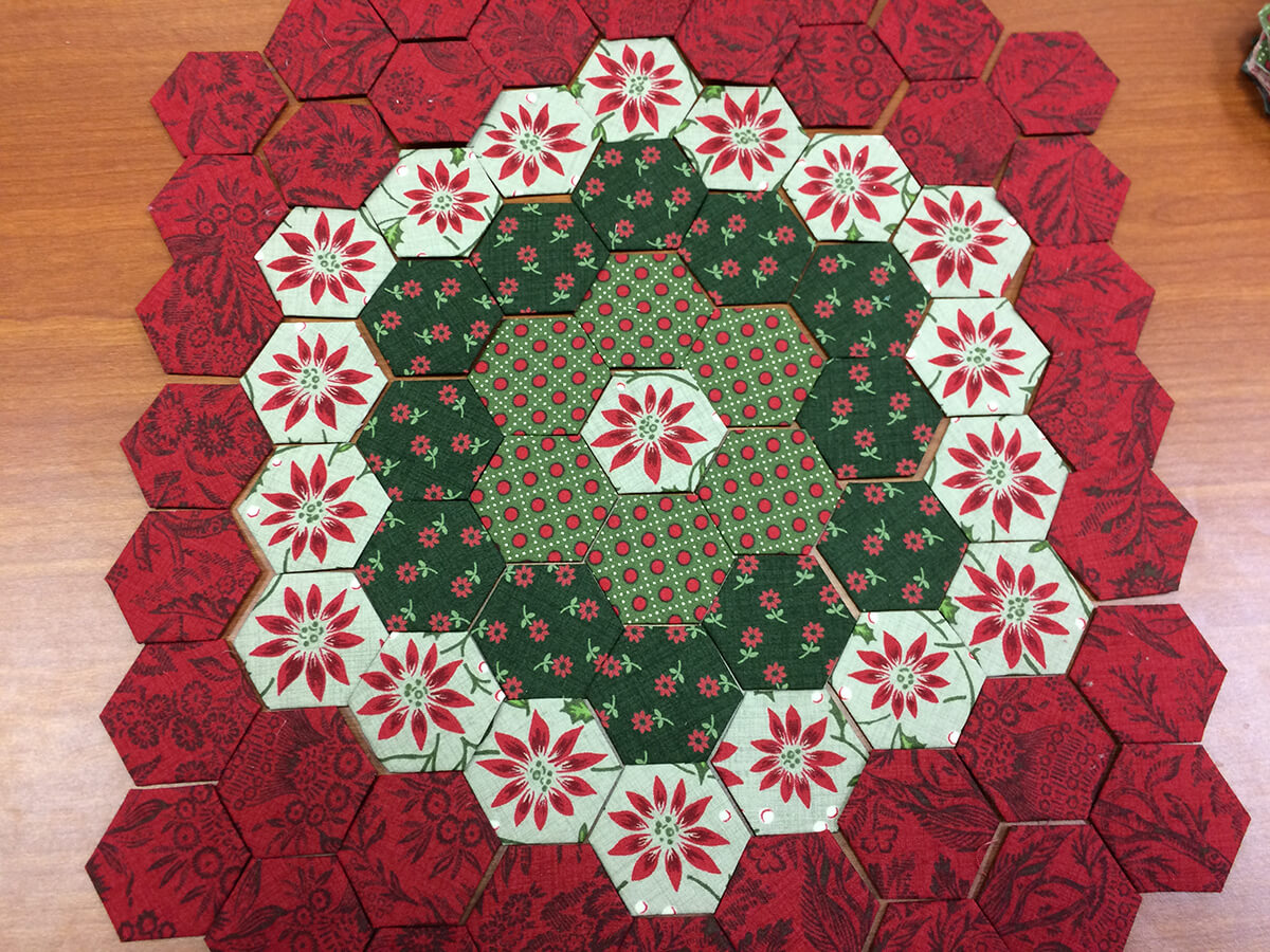 Photo of Hexies arranged for a Christmas pillow project