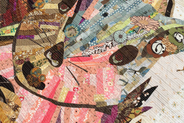 Picture of an art quilt depicting a squirrel holding a nut