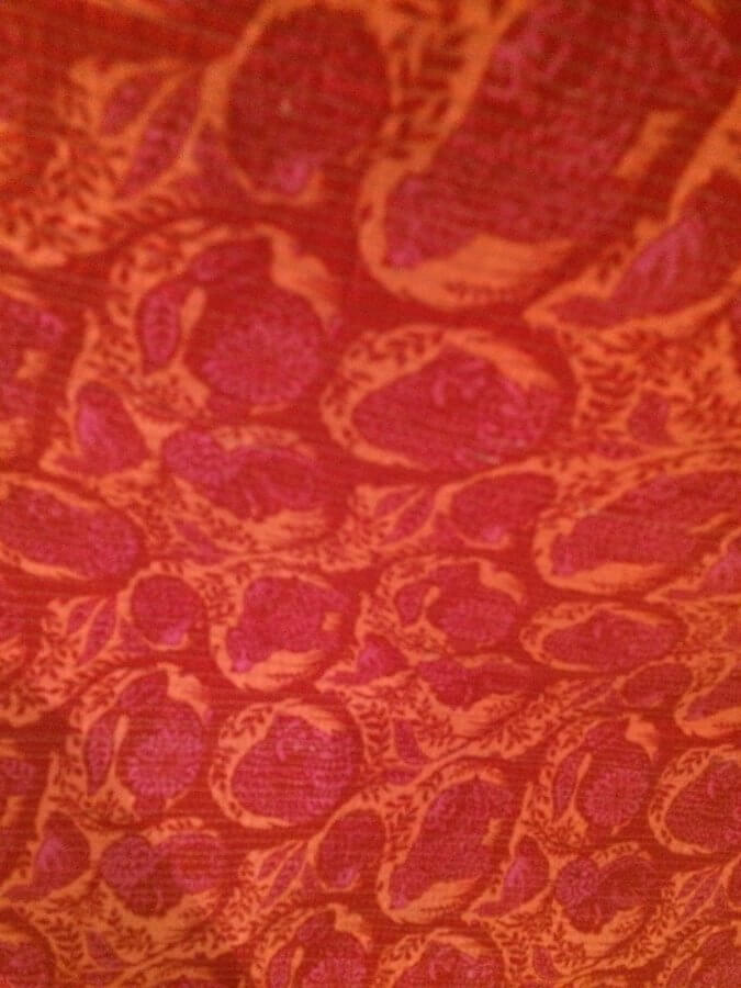 Red orange and pink fabric with forest animals