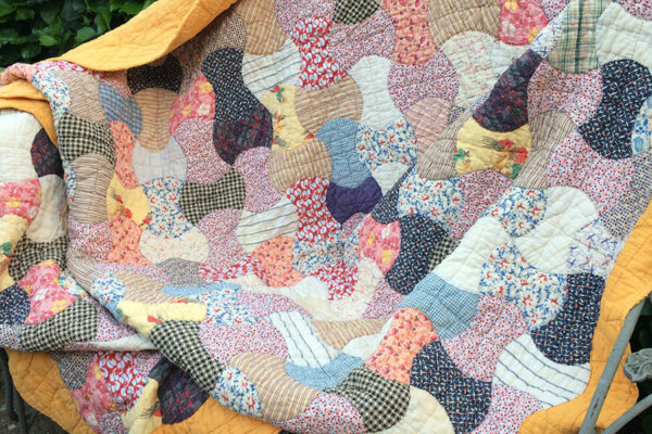 Photo of an 1930's Feedsack Quilt repaired by Scissortail Quilting