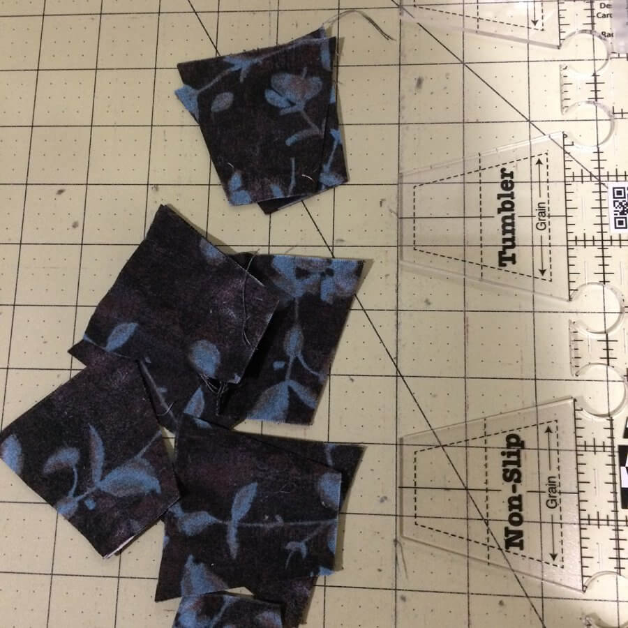Tumbler blocks cut from Strip of fabric using Creative Grids Tumbler ruler