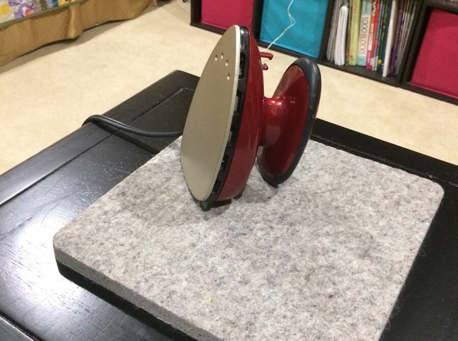 Photo of a small iron sitting on wool pressing mat