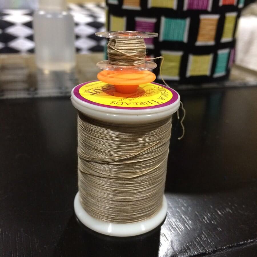 Photo of spool of thread and bobbin attached with Bobbini