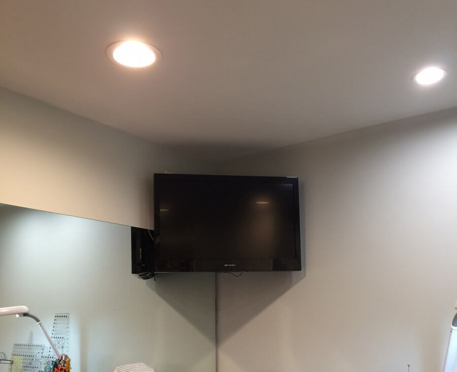 Photo of TV mounted in corner of sewing room