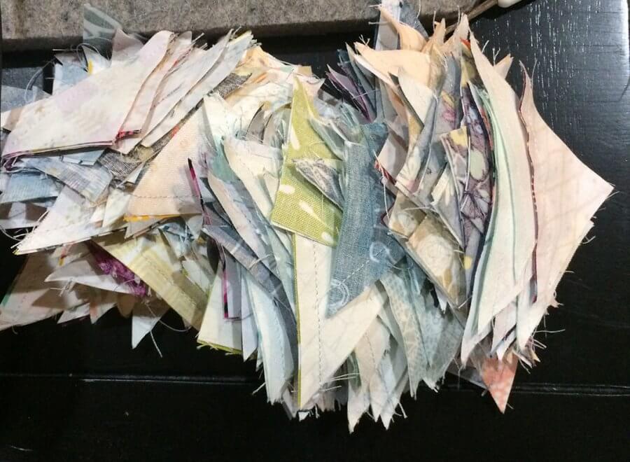 Photo of a pile of HSTs sewn from leftover Quick Corners