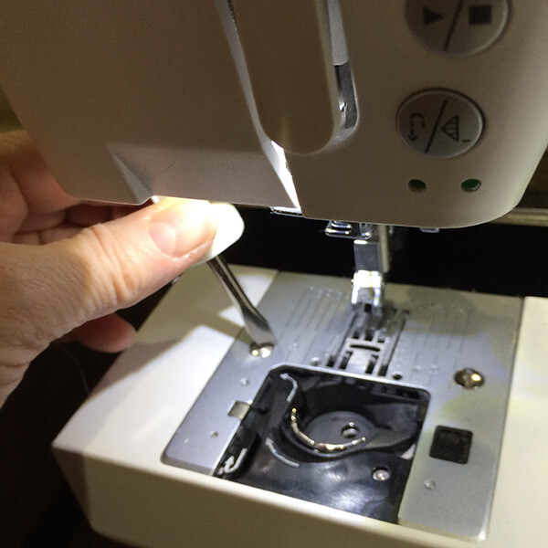 photo demonstrating how to remove switchplate from sewing machine