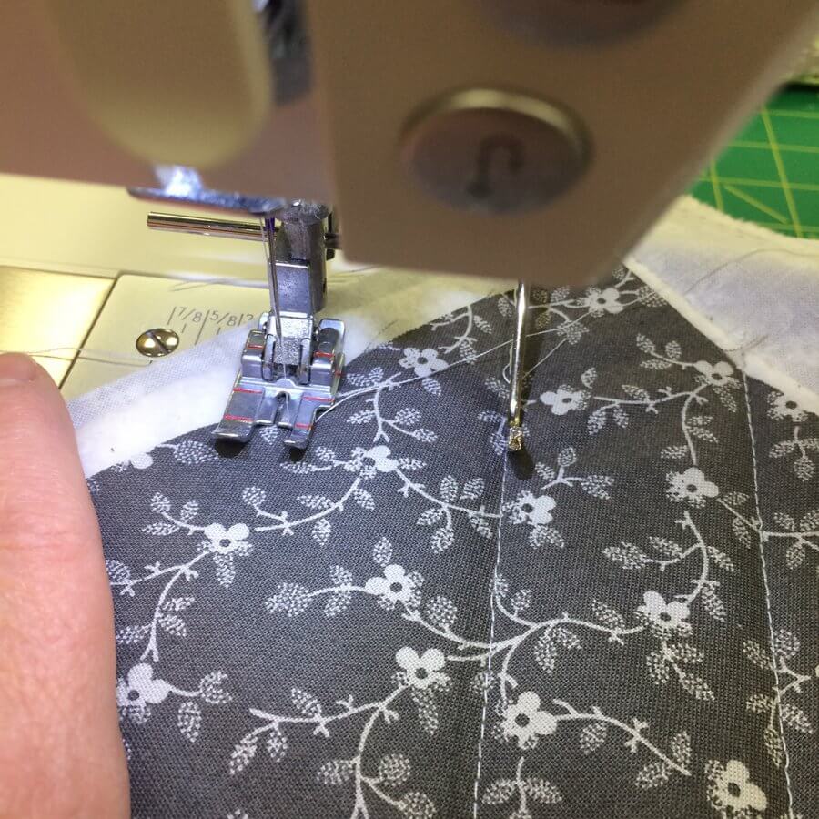 Photo demonstrating use of guilting guide while quilting tiny geese placemats