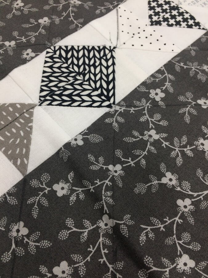 Photo showing placement of plumb lines for quilting on tiny geese placemats