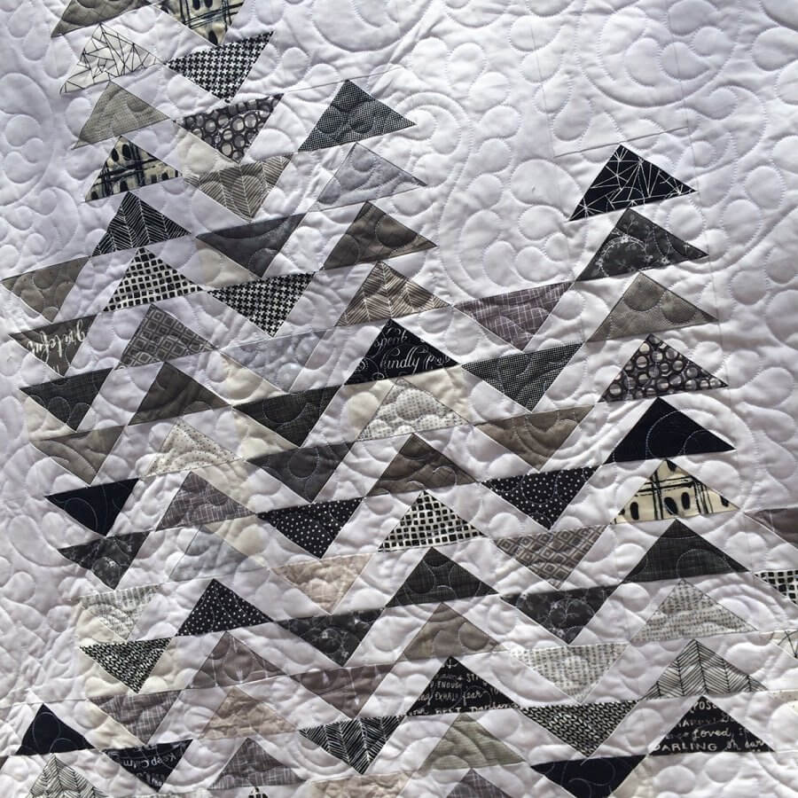 Closeup photo of Sky Quilt Pattern with white background and gray flying geese