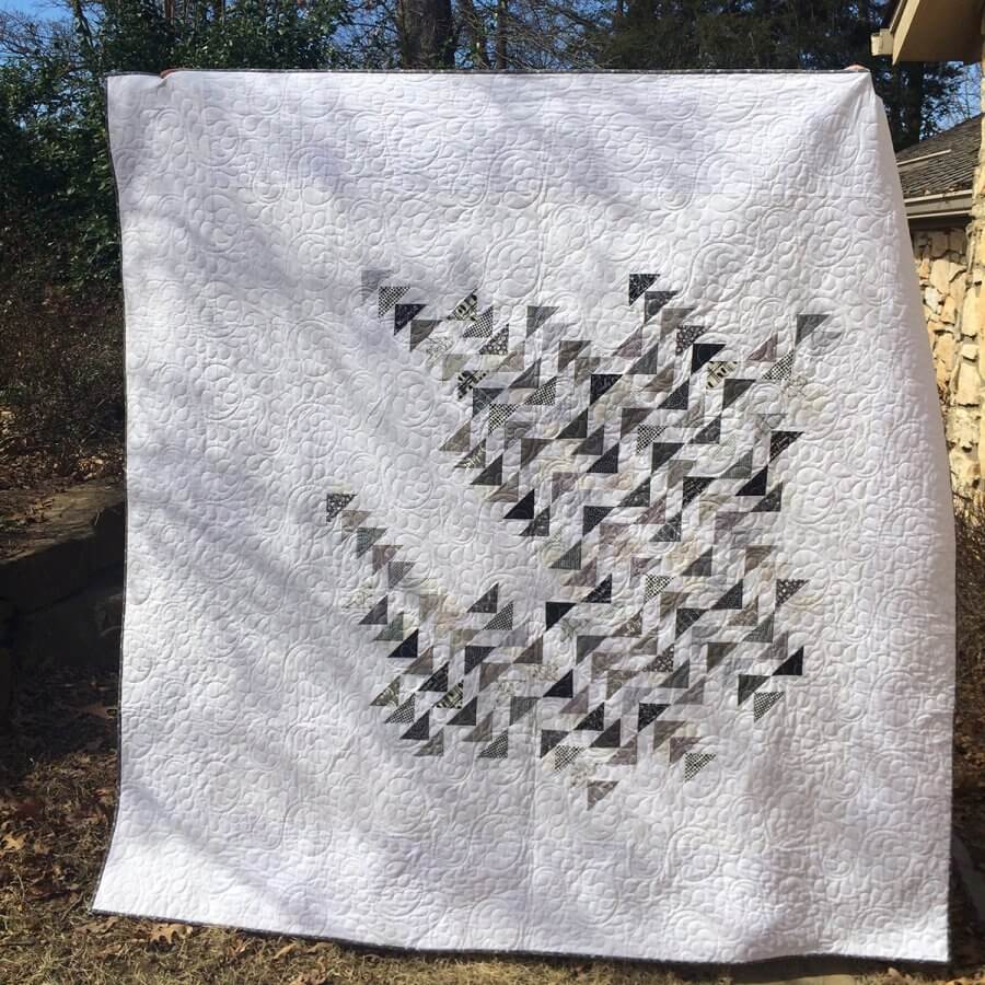 Photo of a white and gray quilt made from the Sky pattern by Zen Chic 