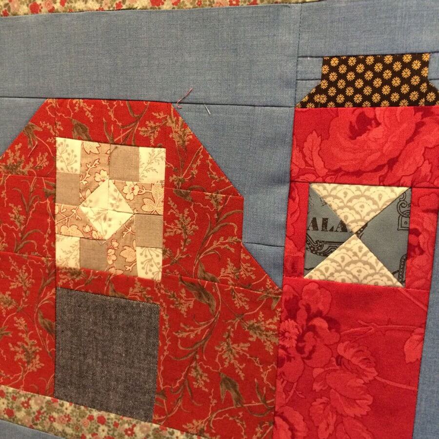 photo of the oh Susannah patchwork set in a barn quilt block alongside a patchwork silo quilt block