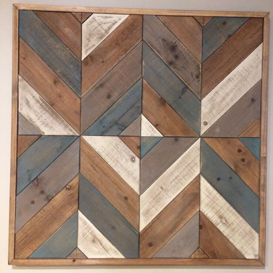 photograph of a large wooden stained barn quilt