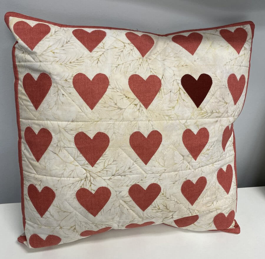 Pillow with appliqued hearts
