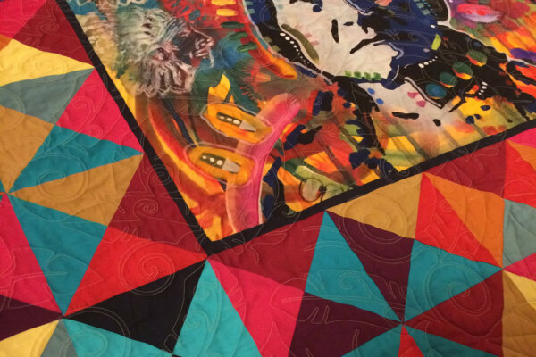 Colorful quilt with center panel featuring Sitting Bull