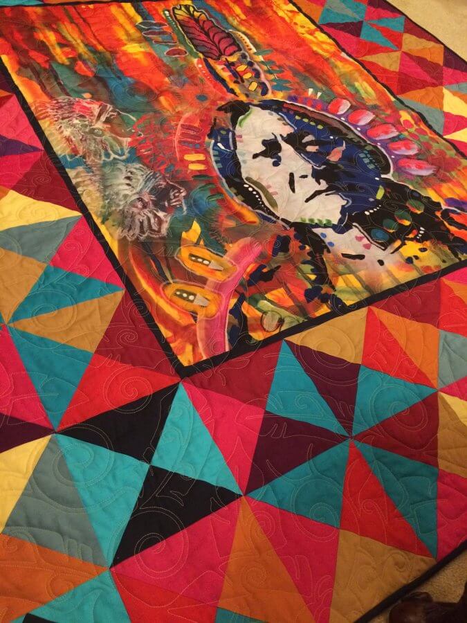 Colorful quilt with center panel featuring Sitting Bull