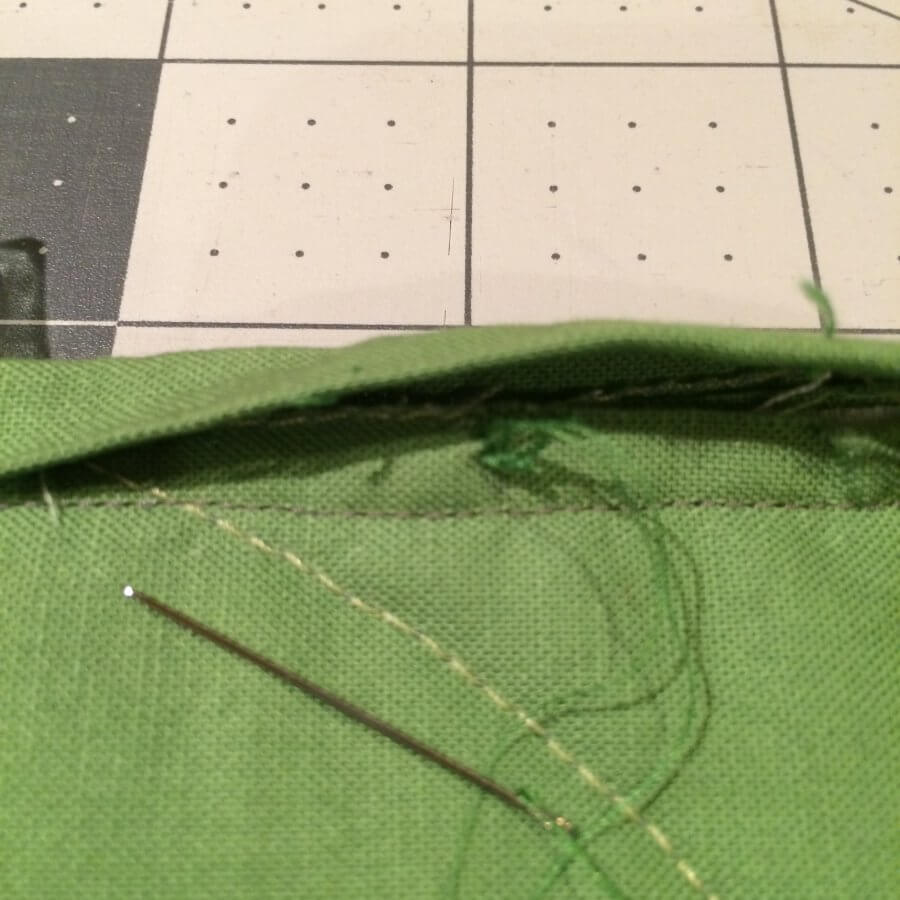 Photo showing thread knotted in the seam allowance of the binding