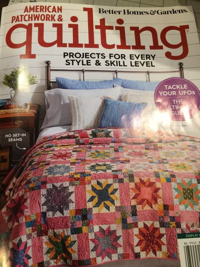 Photo of magazine cover showing a scrap quilt